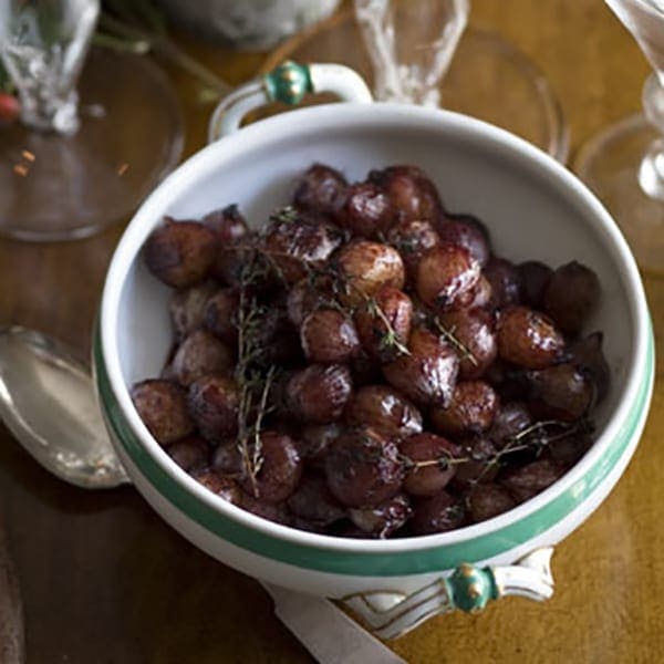 Red wine glazed onions in white tureen on dining table