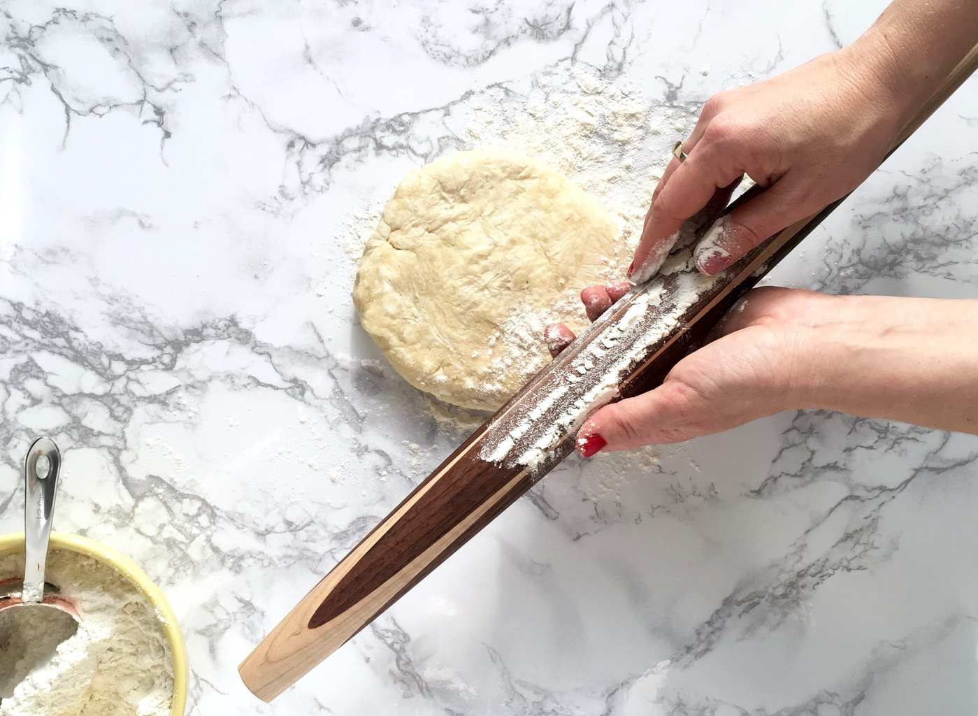 Rolling the perfect pie crust is easy with a few simple techniques and a great rolling pin. Crust on marble with flowered rolling pin