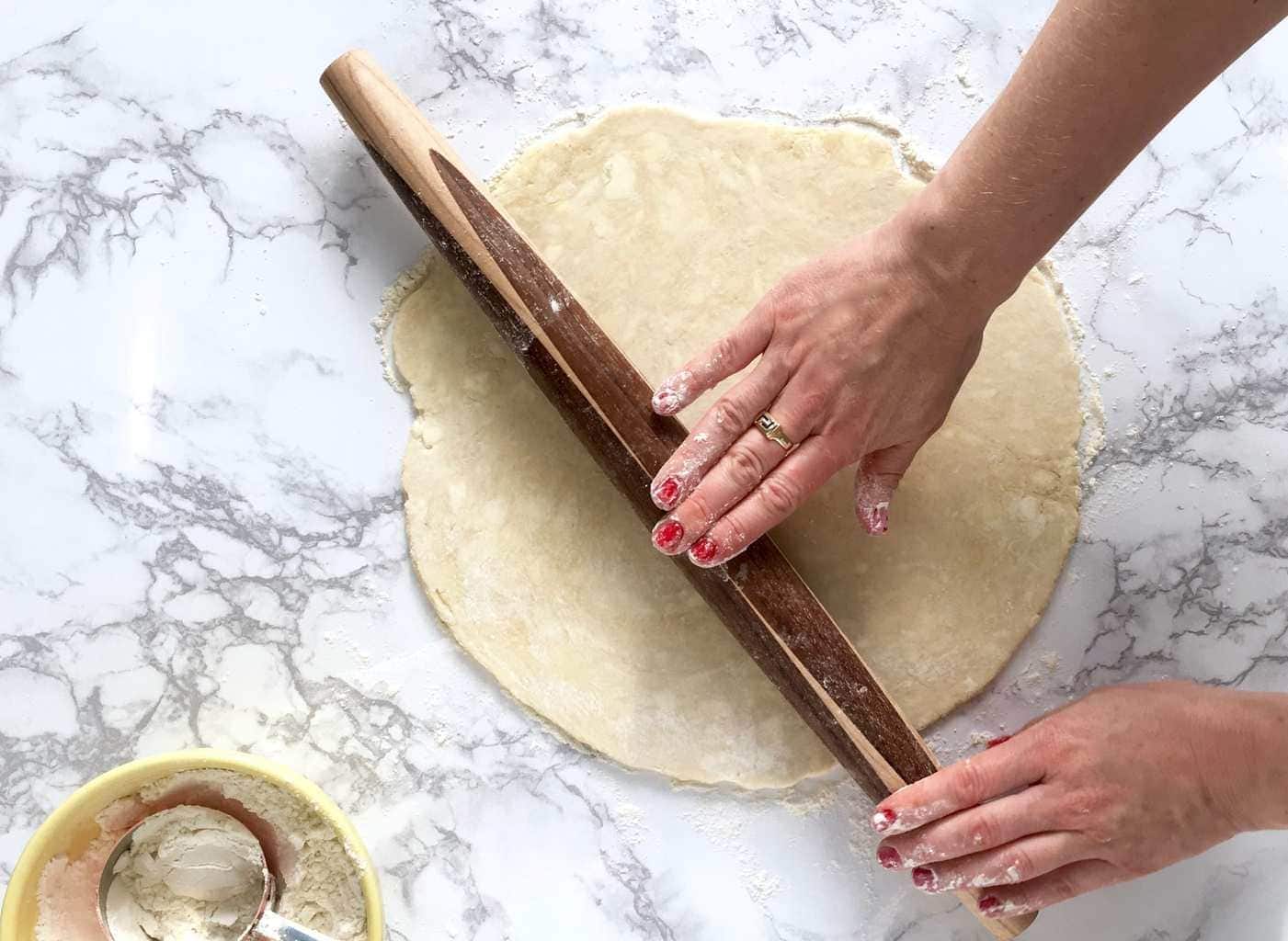 Rolling the perfect pie crust technique with pin and hands