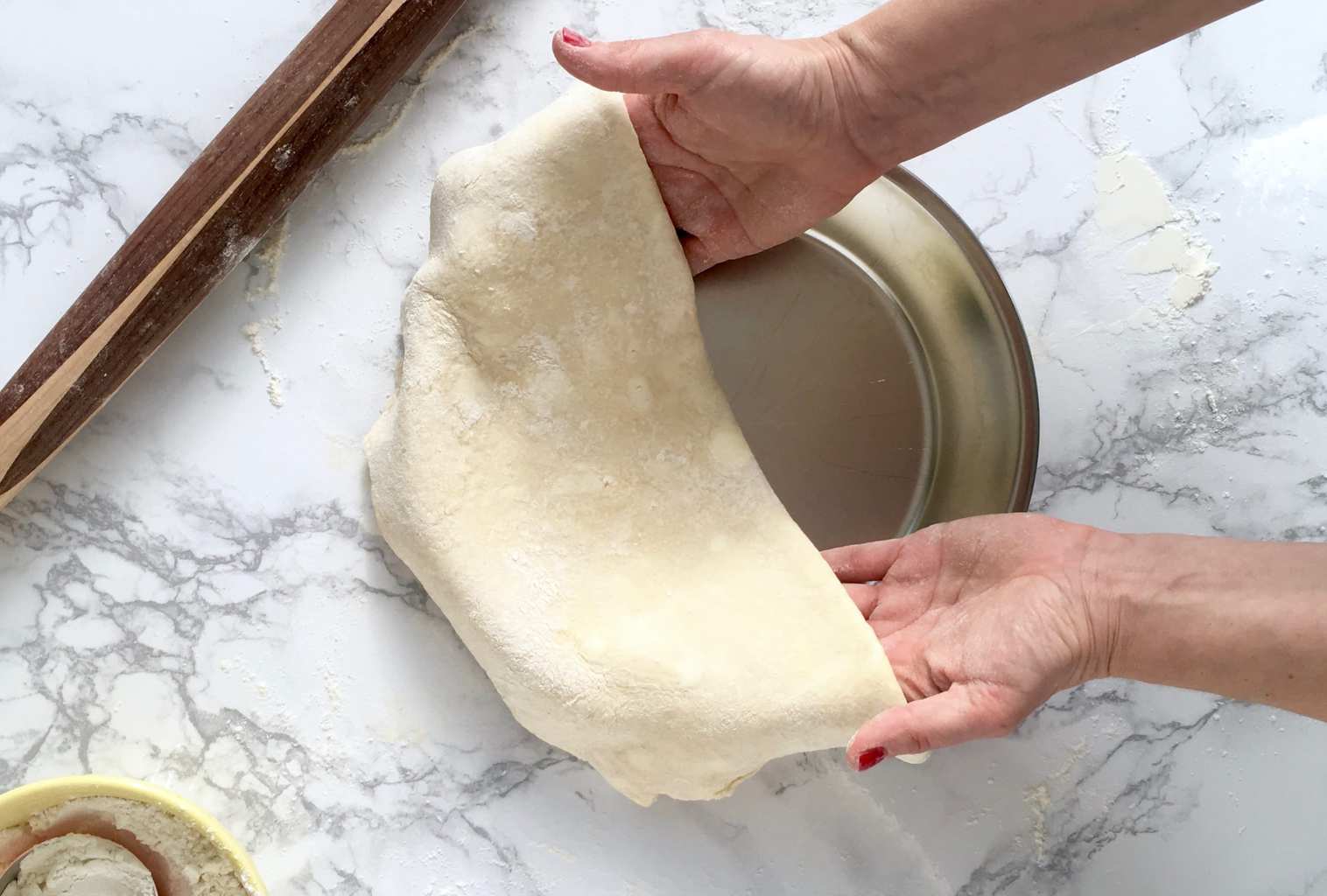 Rolling the perfect pie crust laying in pan.