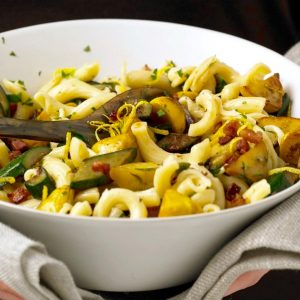 Close up of Squash and Pancetta pasta in white serving bowl