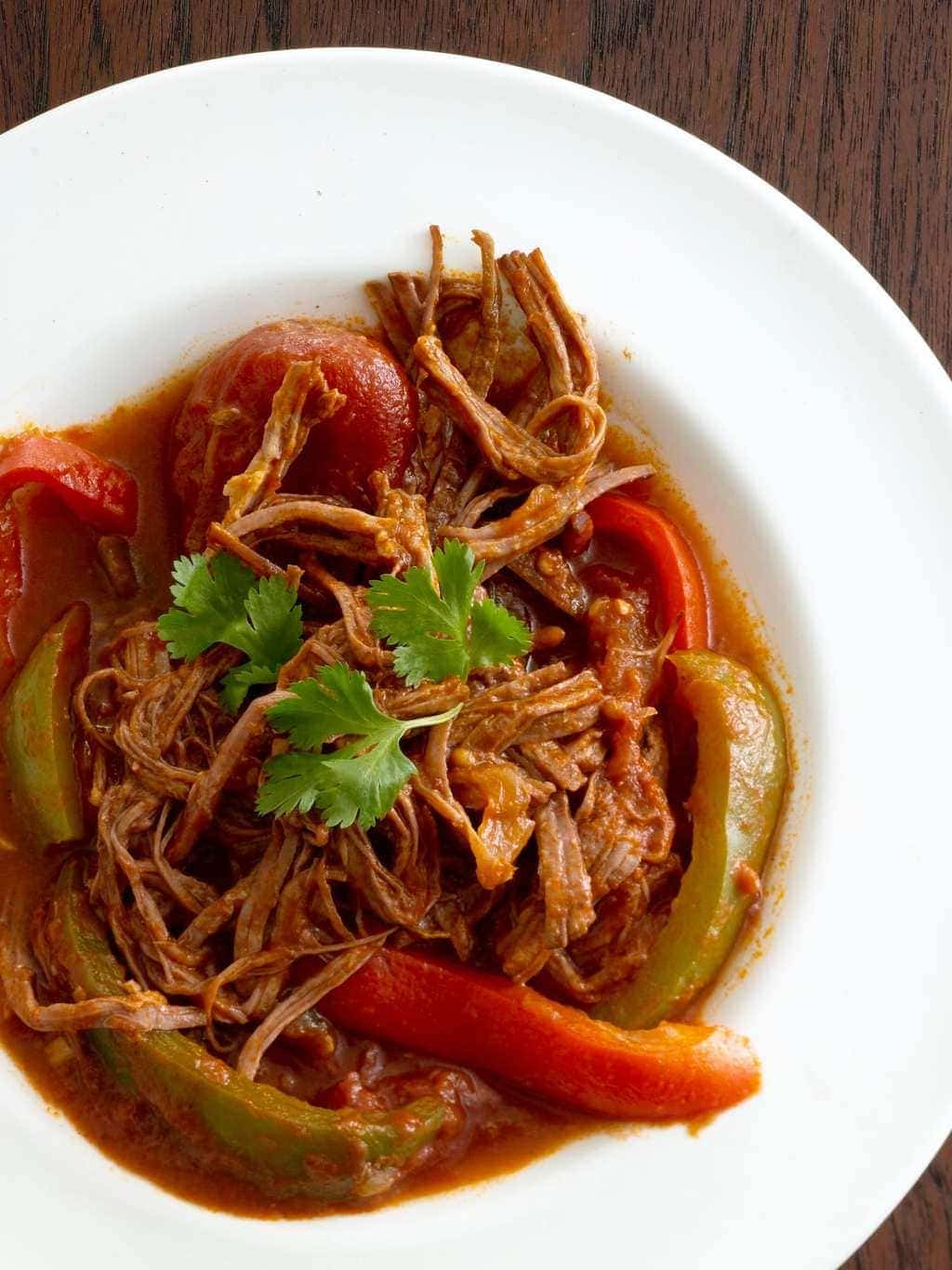  Ropa Vieja Cuban Beef Stew in white bowl with cilantro cropped closely