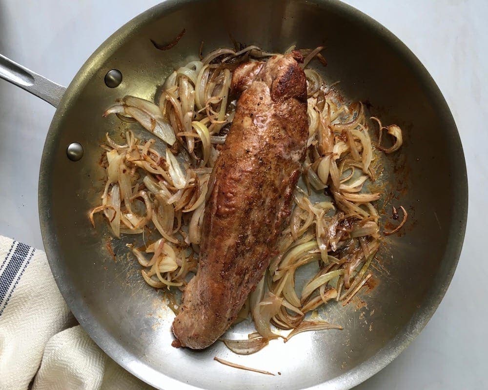 Shallots and tenderloin caramelized in skillet
