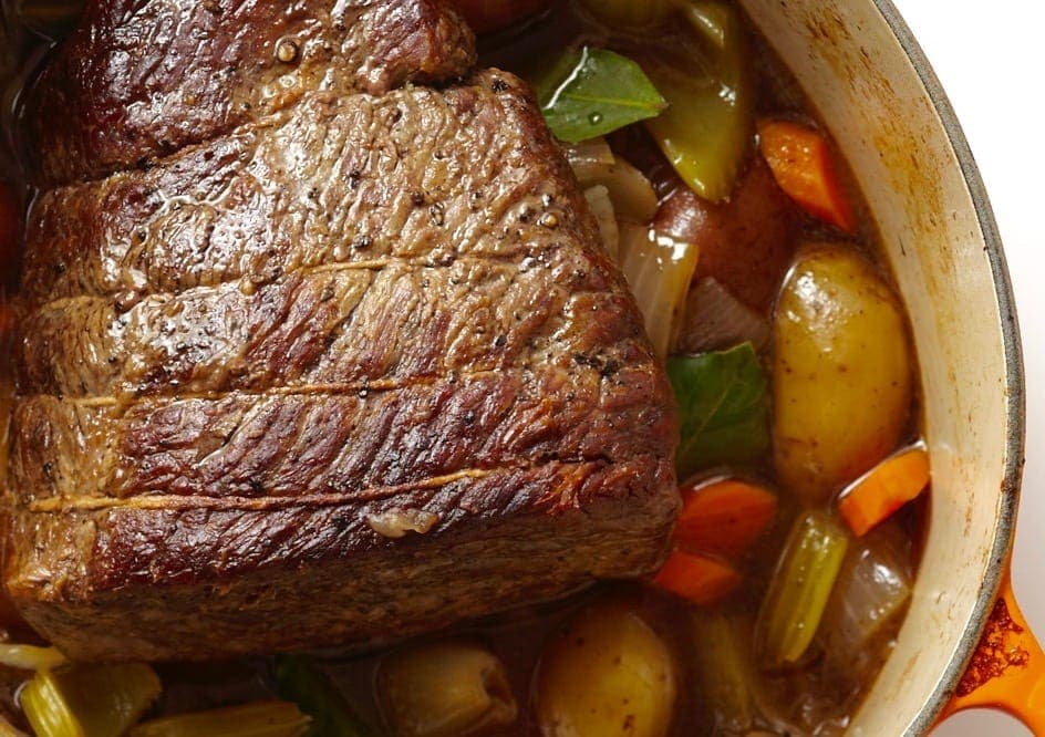 Classic Pot Roast With Vegetables in Le Creuset pot close crop