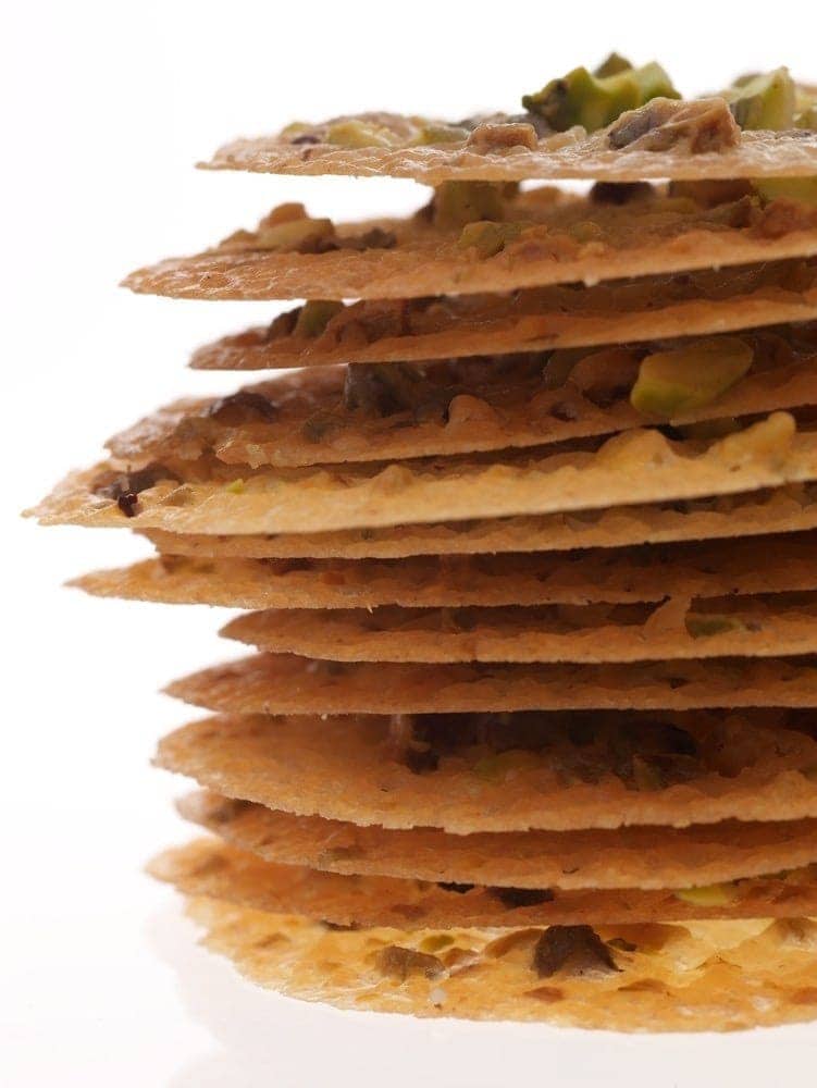 Pistachio Lace Cookies in a tall stack