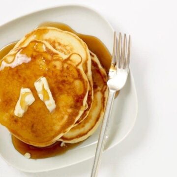pancakes on white plate with syrup