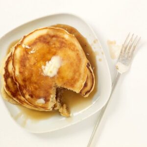 pancakes with a missing bite on white plate