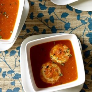 close up of tomato soup with dumplings