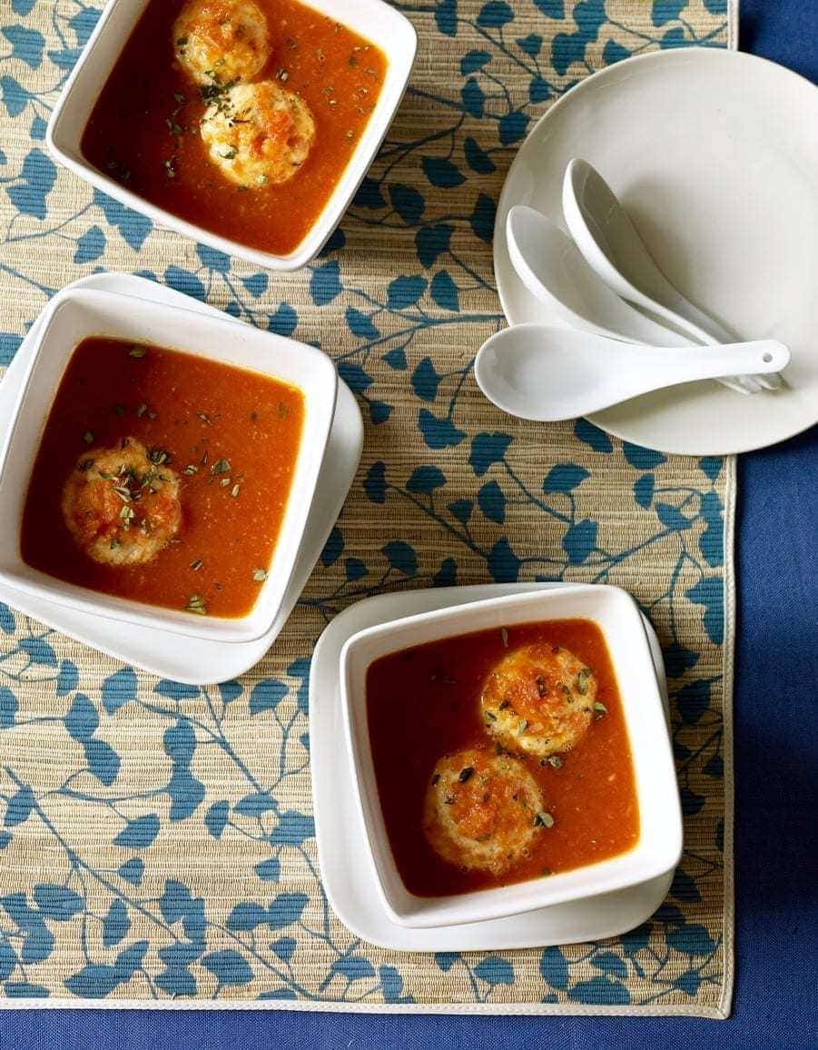 three bowls of tomato soup with dumplings