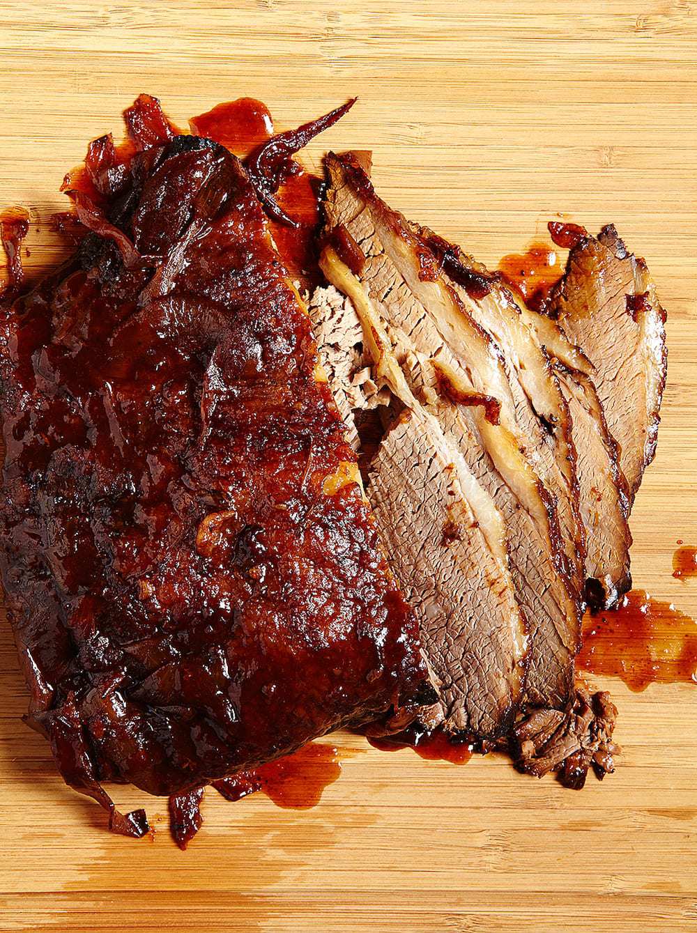 Overhead view of Slow Cooker BBQ Brisket Sandwich sliced on a cutting board. 