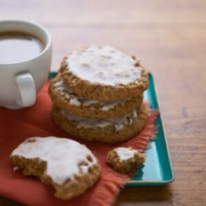 Classic Iced Oatmeal Cookies on teal platter with coffee