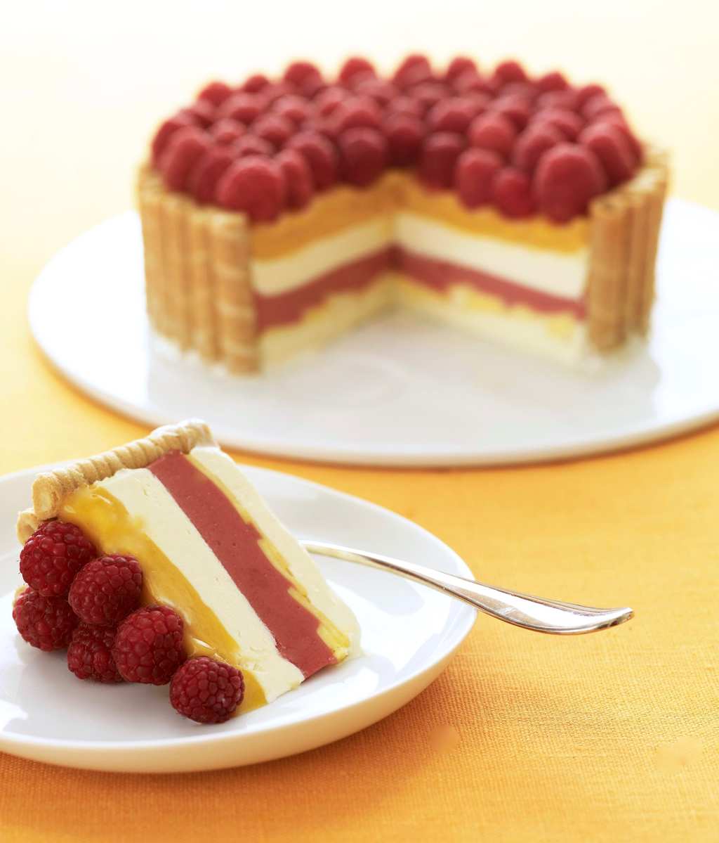 Tara Teaspoon layered icebox dessert with raspberries and mangos  slice with full cake in background