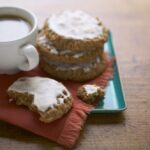 Iced Oatmeal Cookies on teal platter with coffee