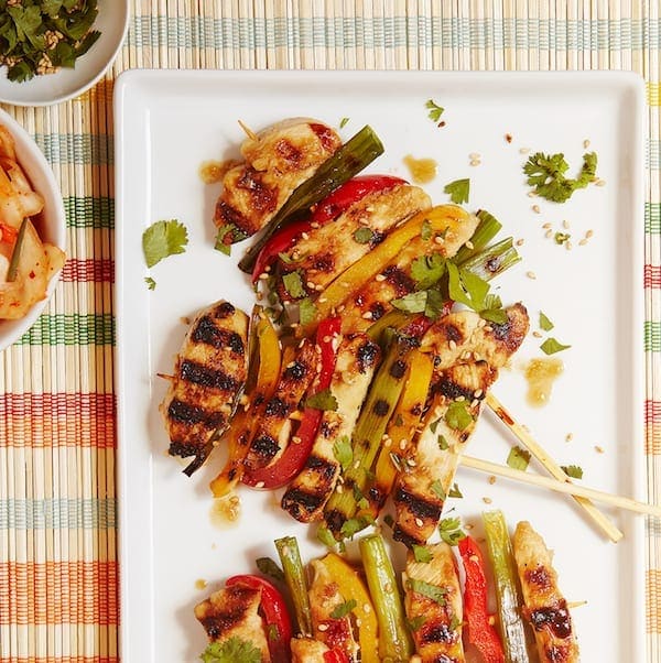 Korean BBQ Chicken Skewers with veggies close crop. 