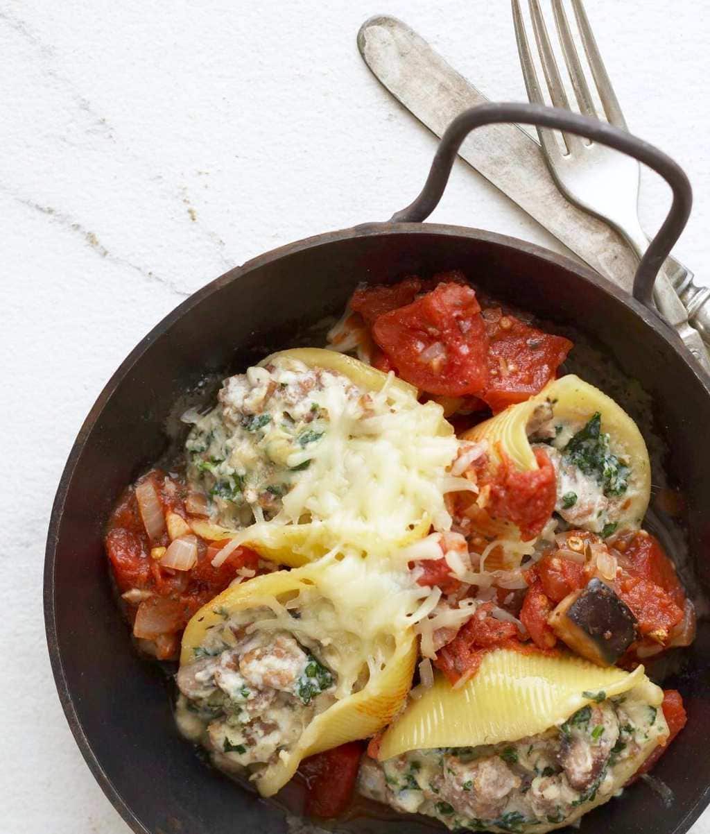 Easy Sausage Stuffed Shells in brown baking dish close cropped.