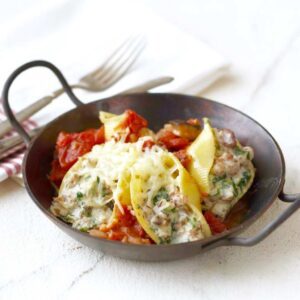 Easy Sausage Stuffed Shells in small metal wok pan with handles