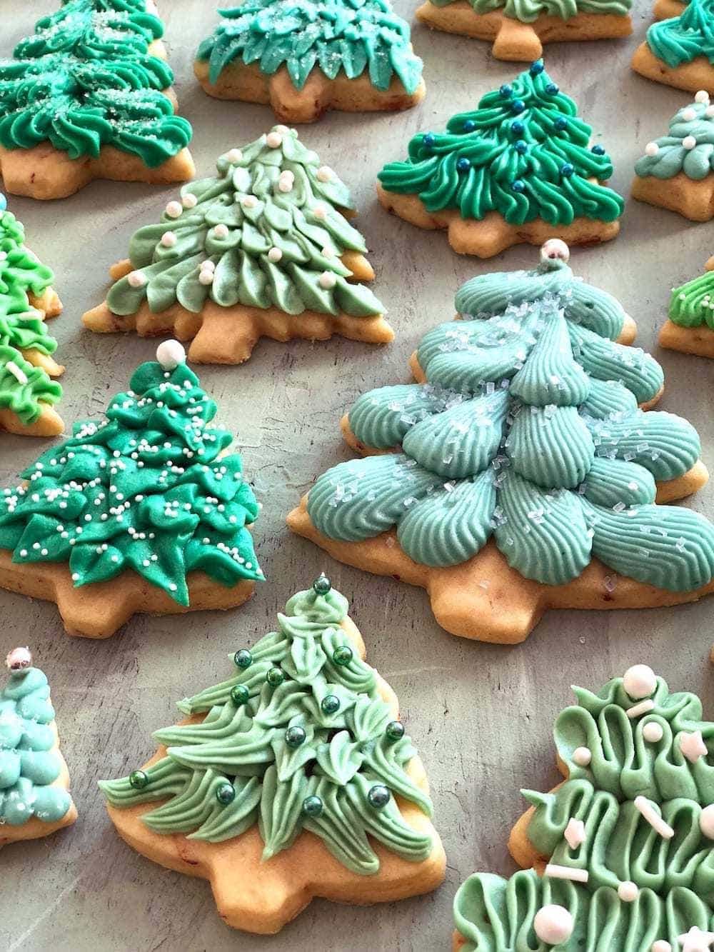 Frosted Christmas tree cookies on a  gray background