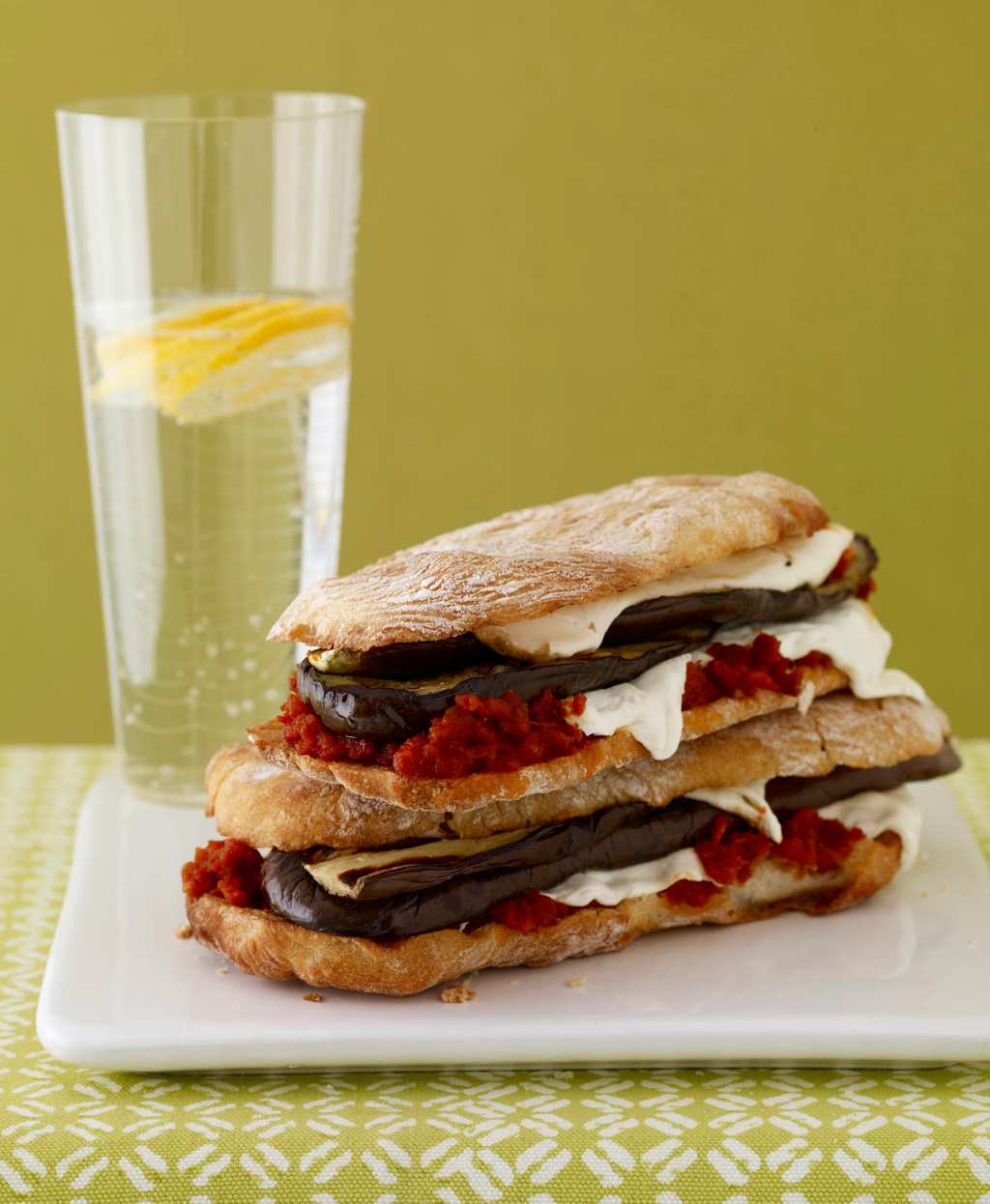 Mozzarella and eggplant panini on plate with water