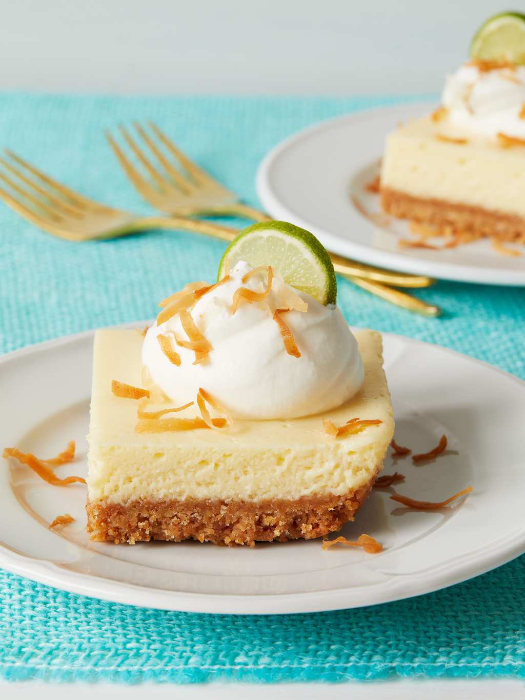 Coconut Key lime Bars on white plate and turquoise background