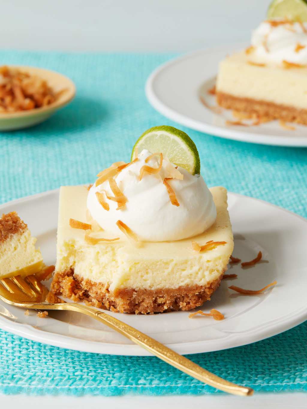 Key Lime Bars with bite out and gold fork