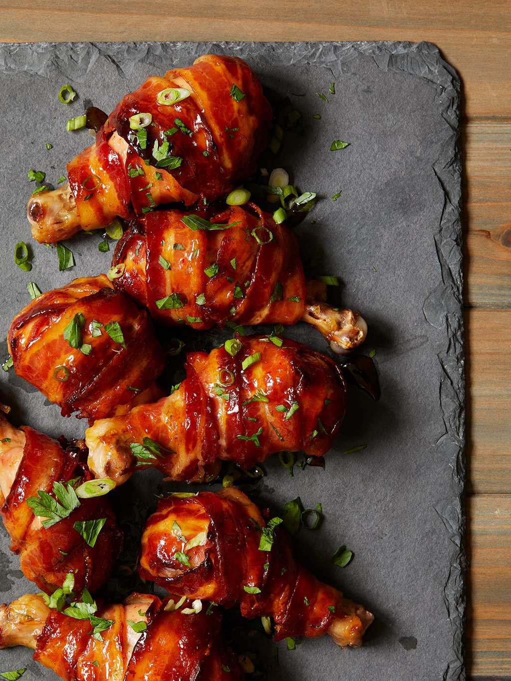 spicy maple bacon chicken drumsticks on slate