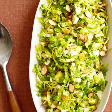 Shredded Brussels Sprouts with Orange and Almond on a linen tabletop