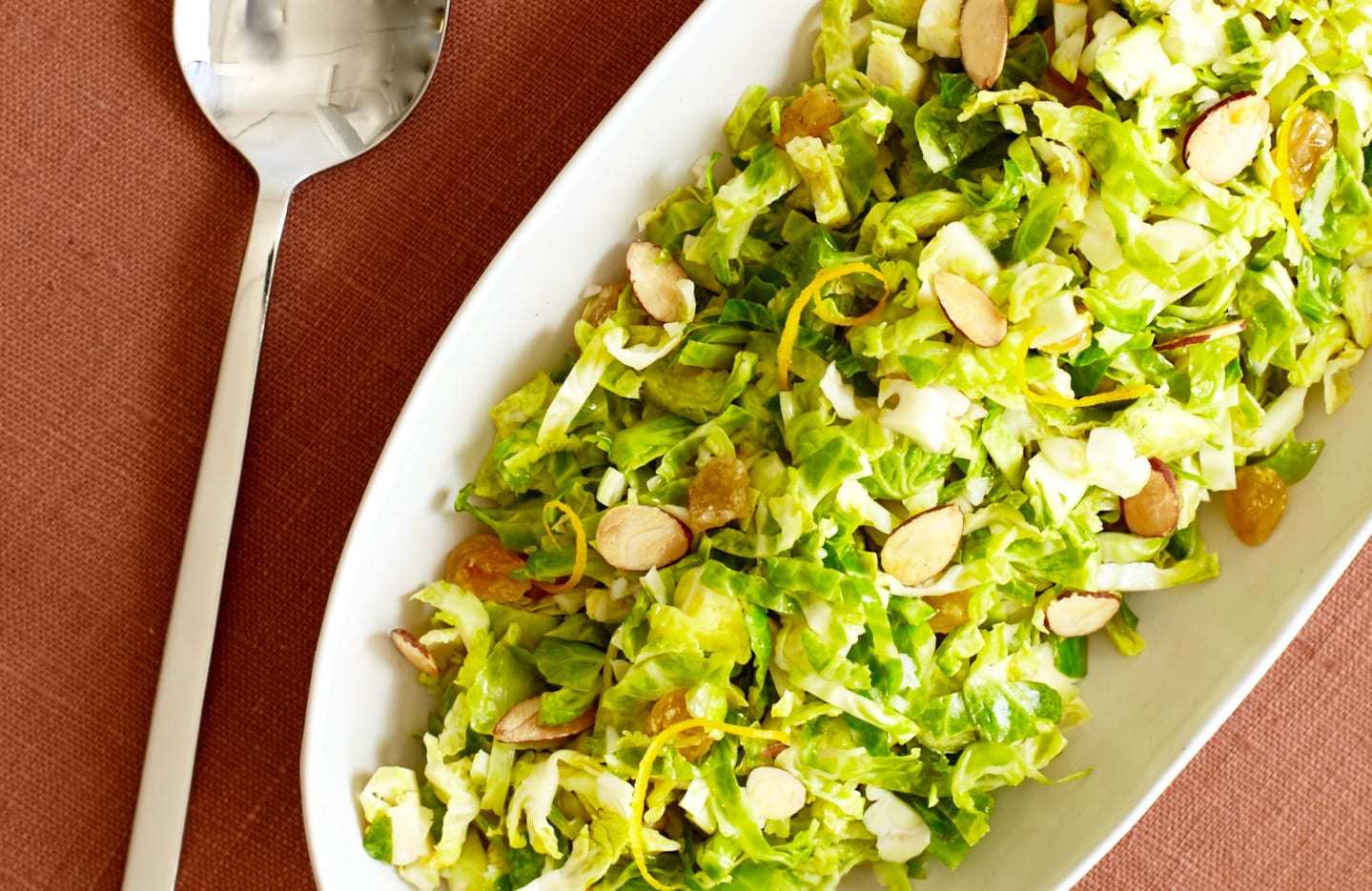 Shredded Brussels Sprouts with orange and almonds close up