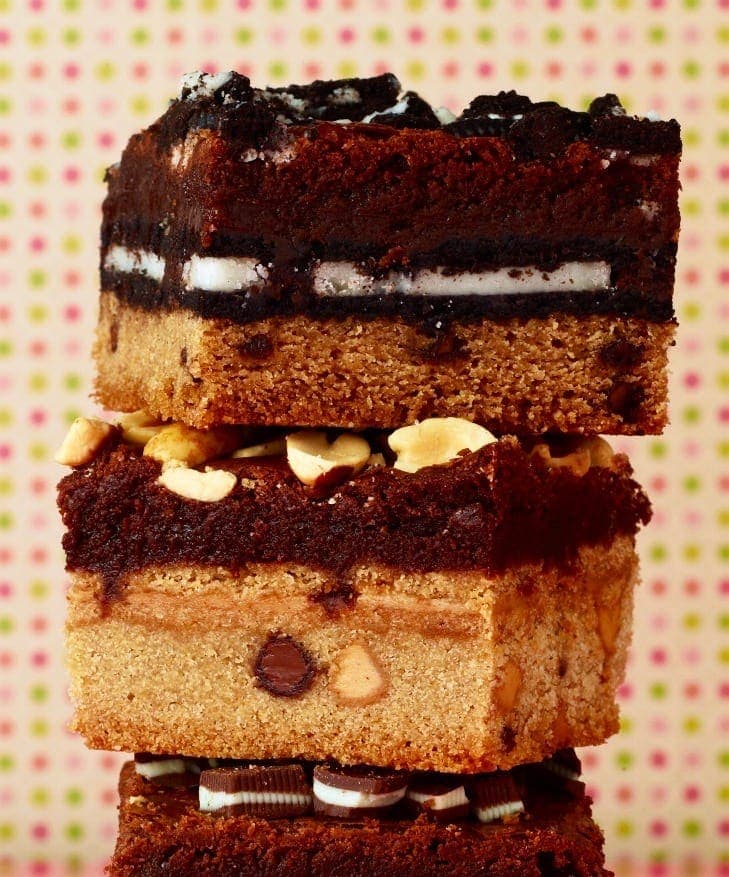 The ultimate cookie stuffed brownies stacked in a close crop