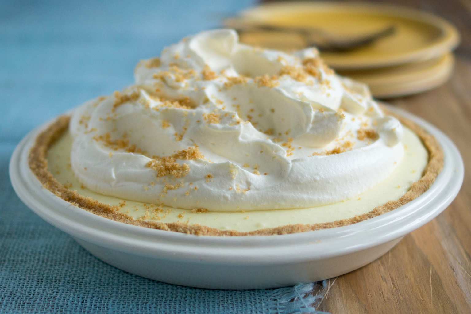 An easy no-bake lemon pie on blue placemat in white pie pan