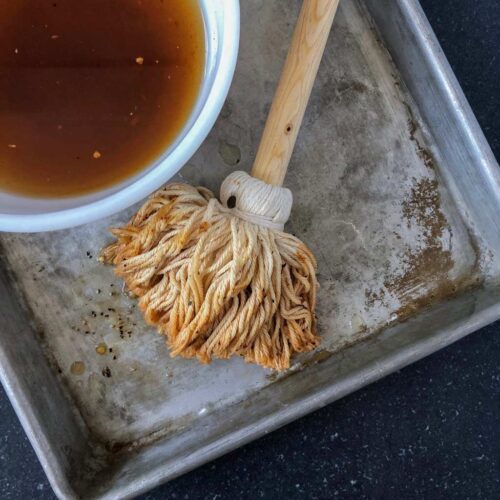 bbq mop sauce with mop in aluminum tray