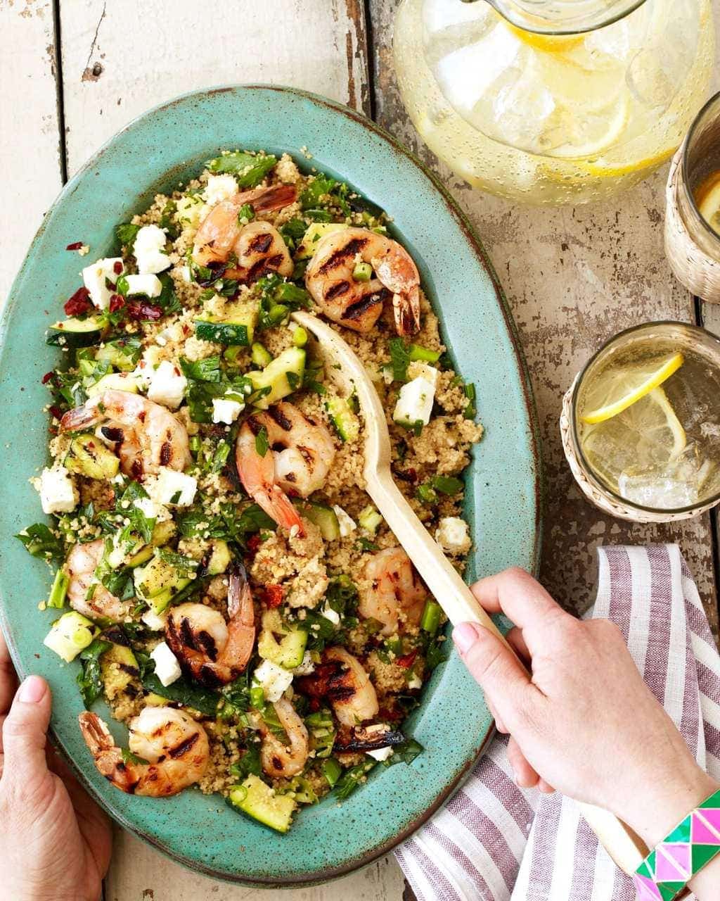 Grilled shrimp recipe with zucchini couscous  in green bowl plus lemonade