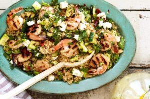 Grilled shrimp with zucchini and couscous with serving spoon