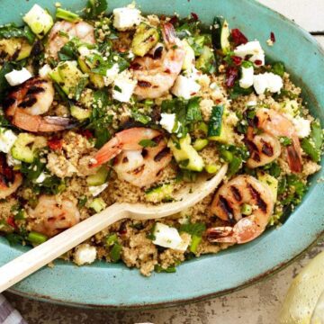 Grilled shrimp with zucchini and couscous with serving spoon