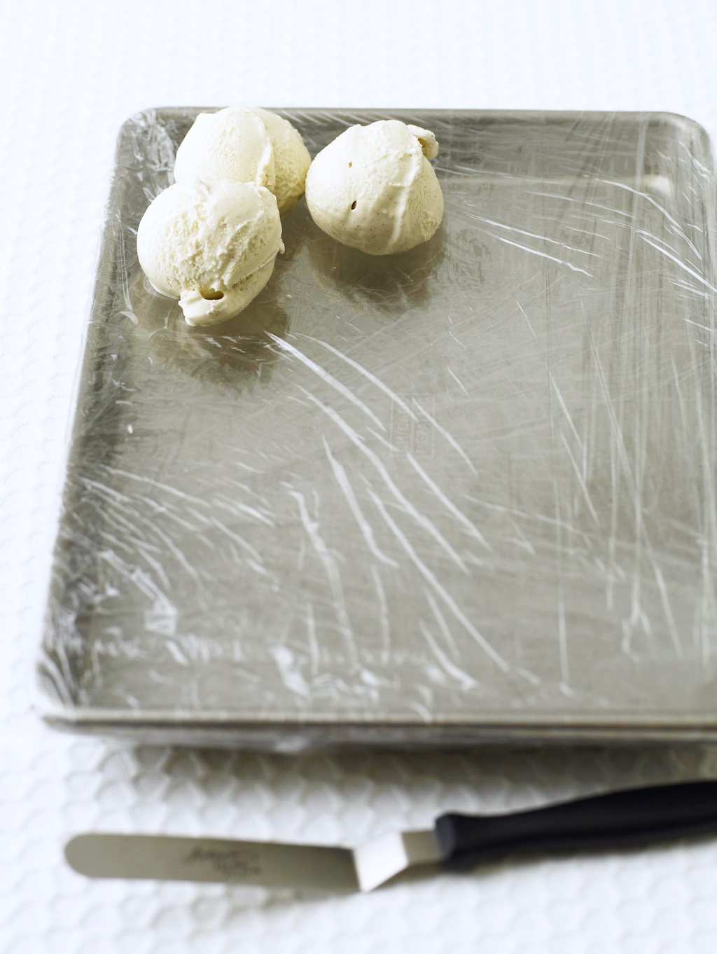 Freezing balls on a plastic-wrapped sheet tray