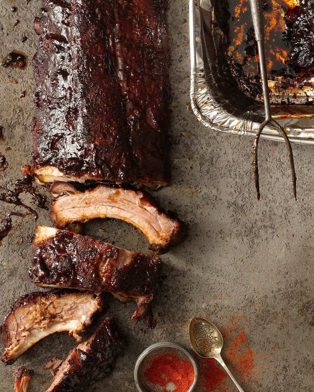 Kansas City style ribs with smoking pan and fork