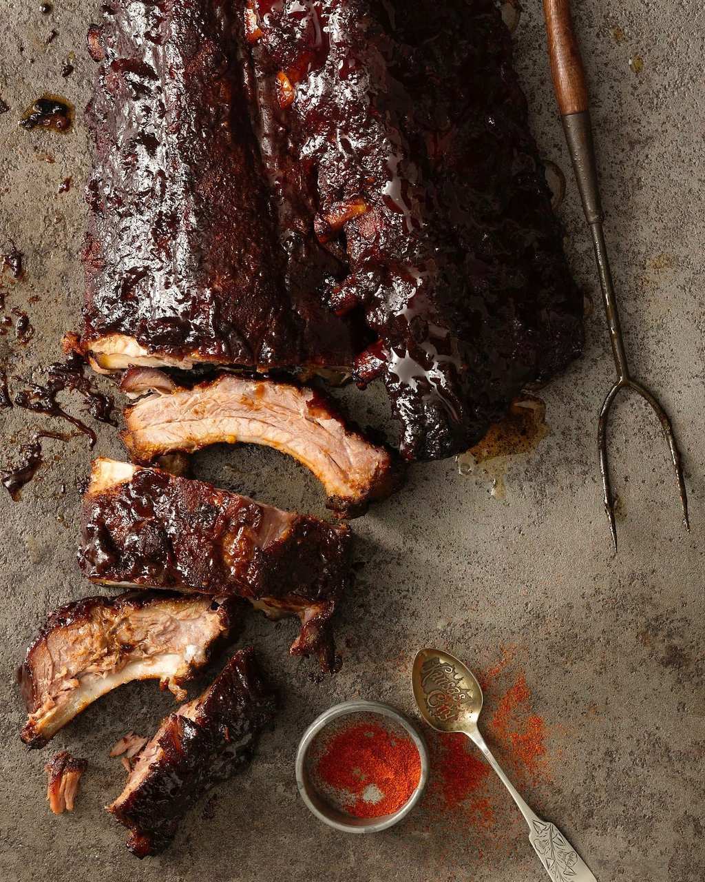 Kansas City Ribs with sauce right off the grill, a few ribs cut