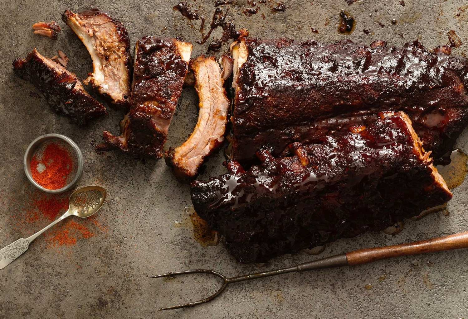 BBQ ribs on gray background, w fork