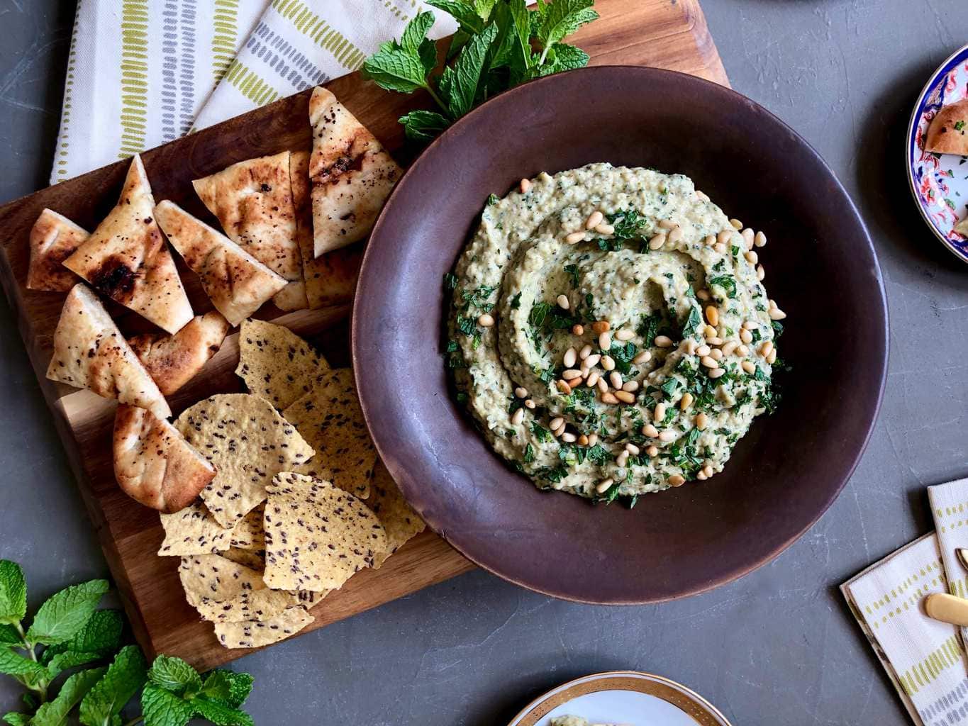 grilled zucchini baba ghanoush dip in a bowl with pita