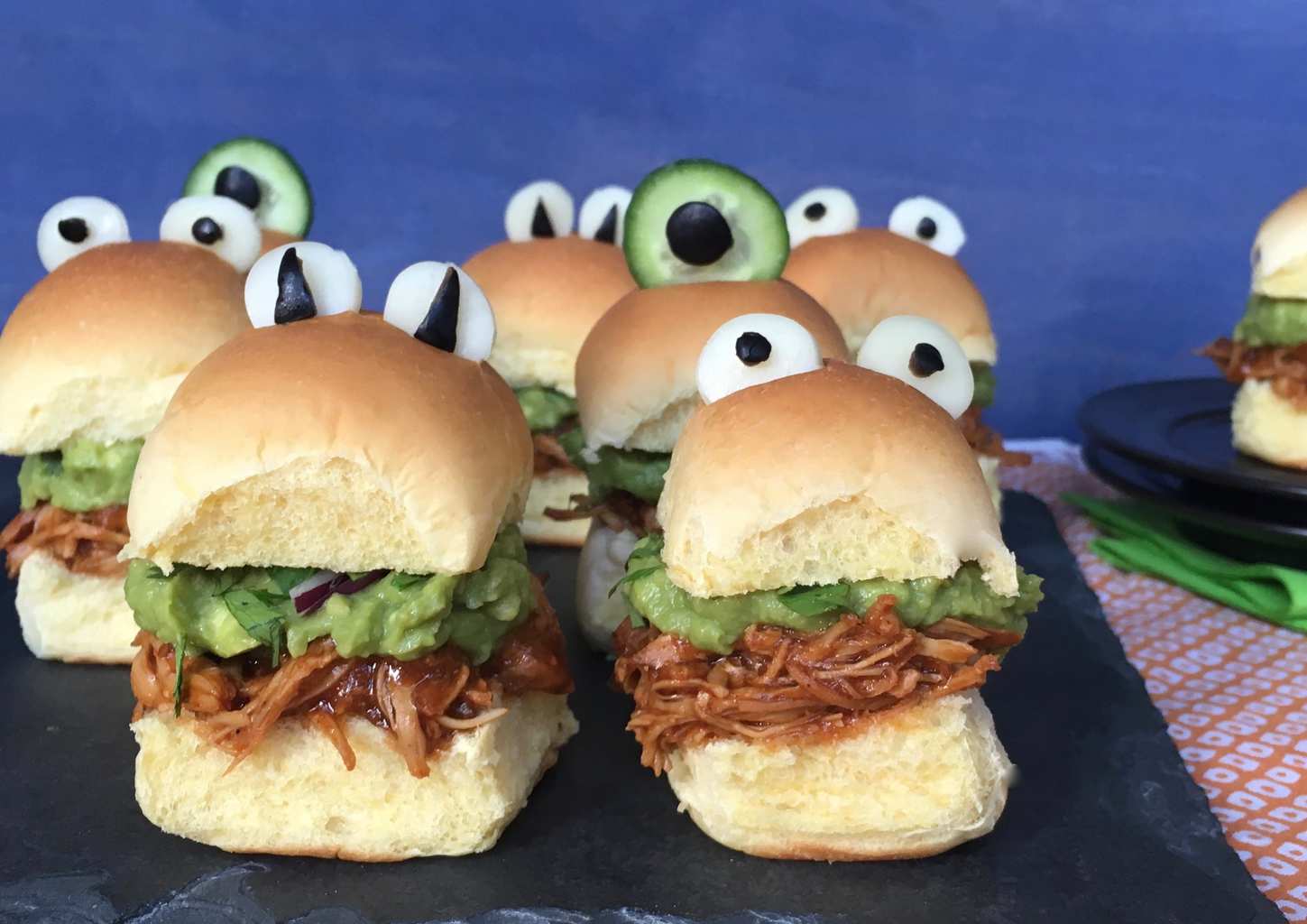 Halloween monster chicken sliders on a black slate