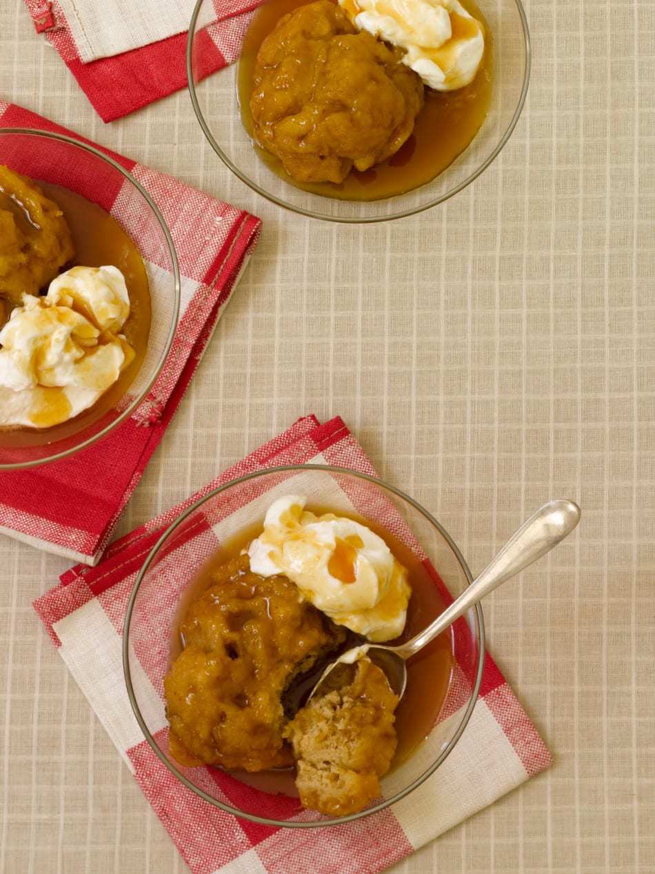 apple dumplings in bowls with cider sauce