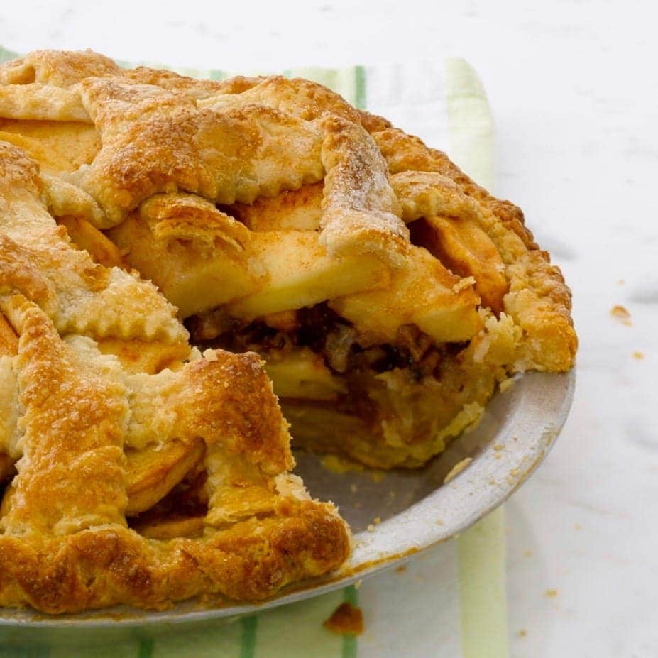 apple pie with pecan streusel on green linen