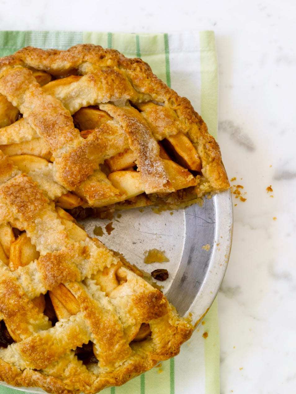 apple pie with pecan streusel on green linen overhead