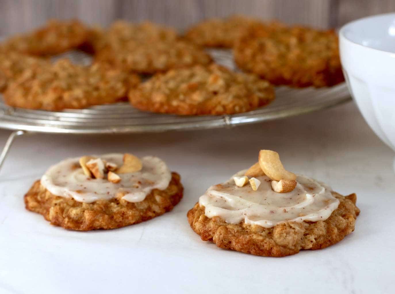 Cashew Oatmeal cookies with brown butter frosting on cooling rack