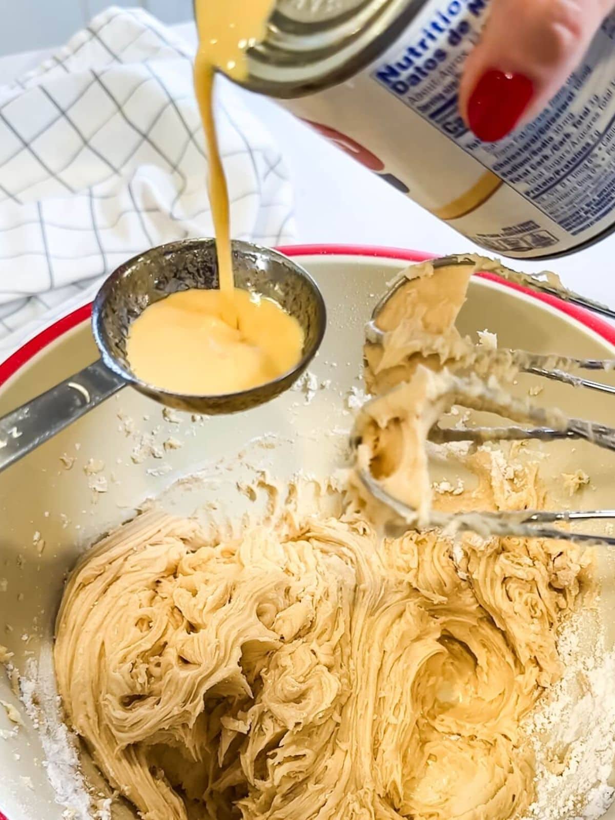 Adding a little evaporated milk to browned butter frosting to thin it.