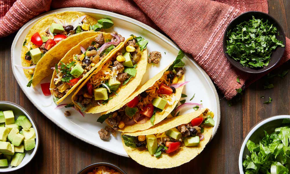 Chili Beef Tacos ready to serve on white oval platter