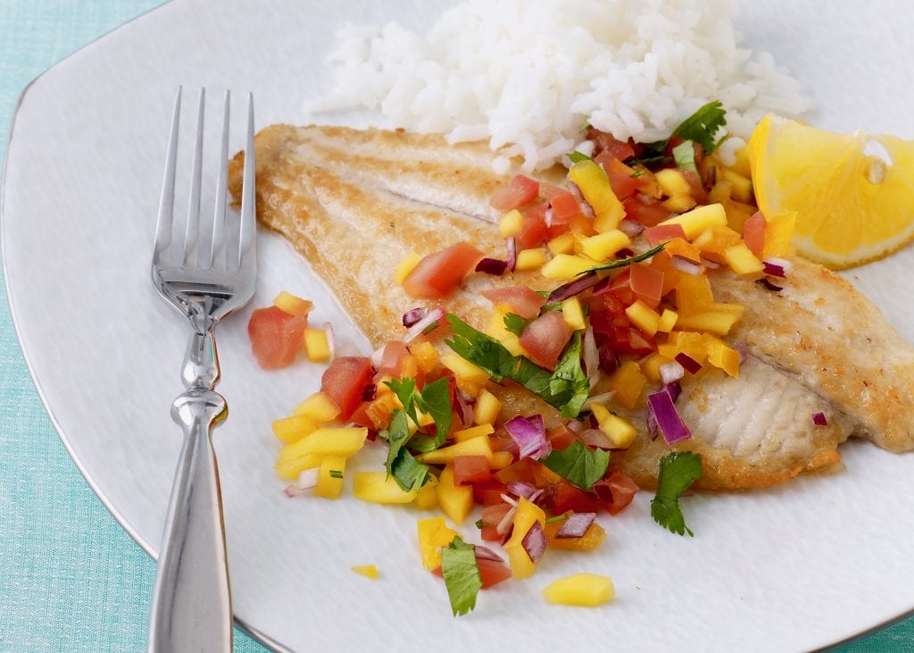 make fish with mango salsa for dinner on a plate with a fork