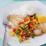 fish on a plate with mango salsa