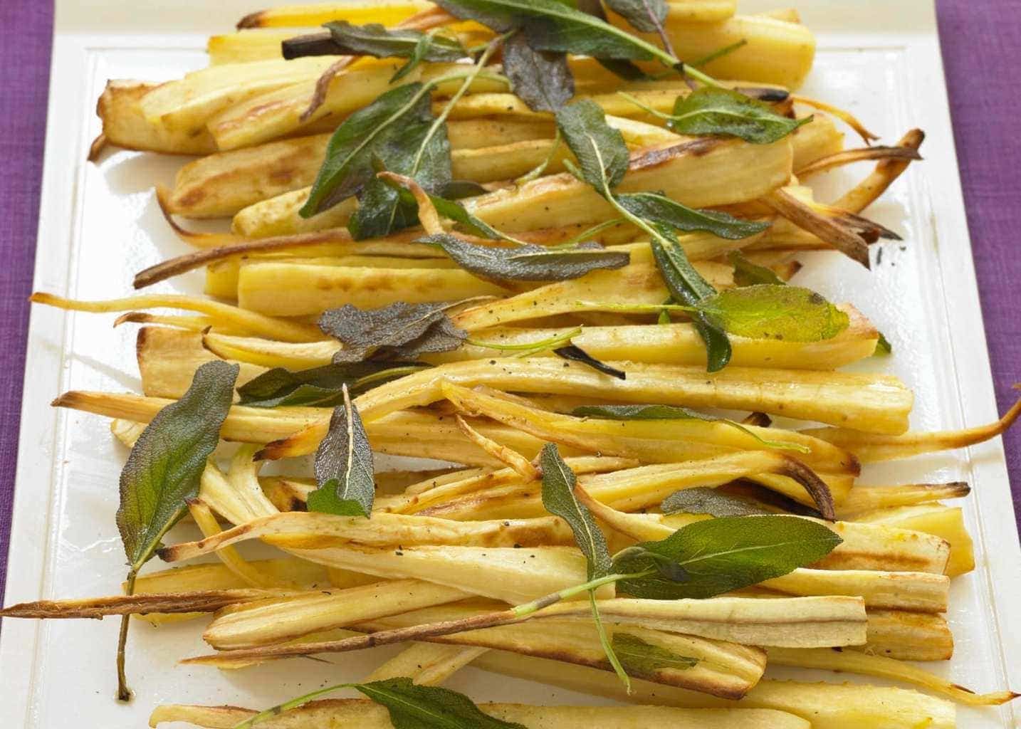 Roast Parsnips on a platter with fried sage