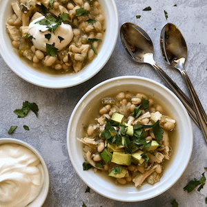 Chicken Chili Verde with white beans in white bowls