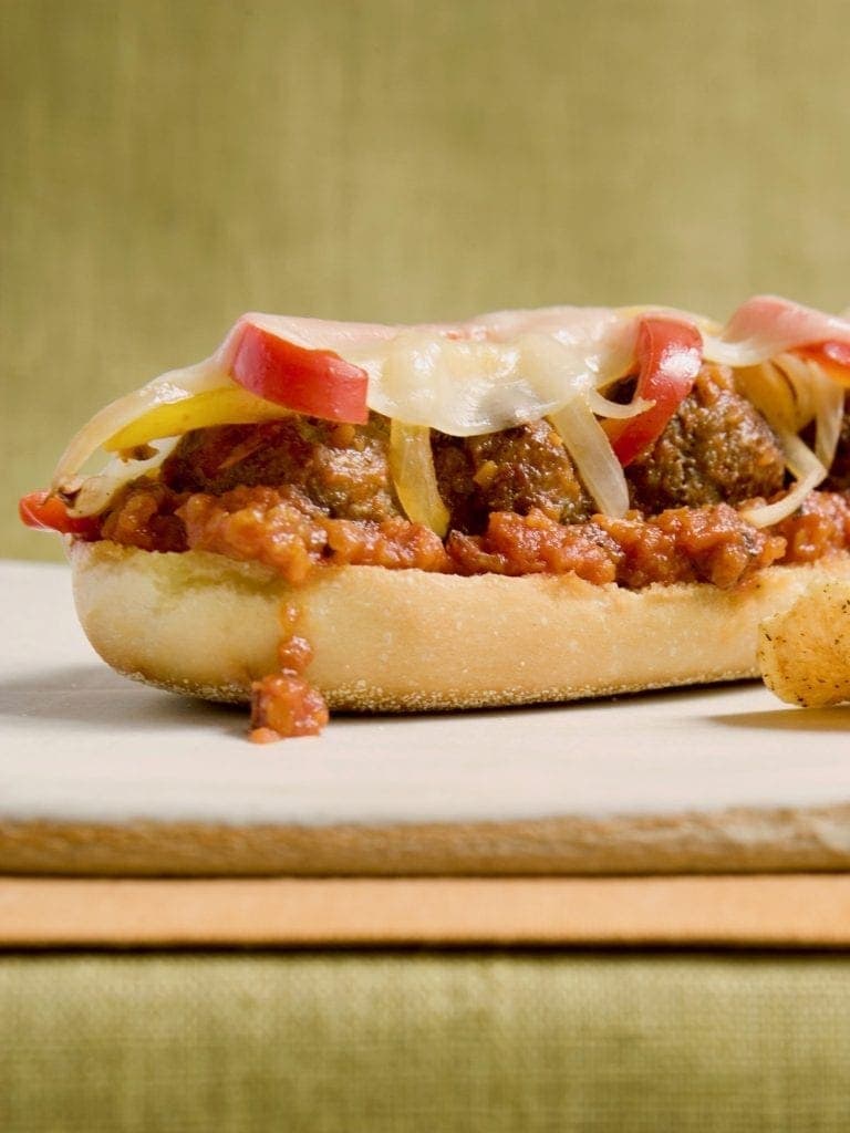 A delicious open face meatball sub on a cutting board